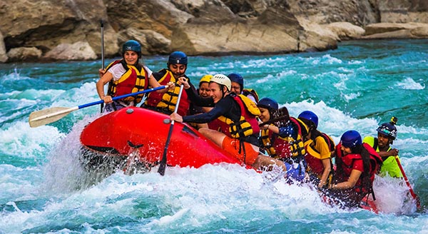 adventurers navigating a white water rapids