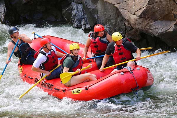 exciting rafting trip with people paddling through rough water